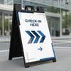 Black sandwich board A-frame sign displaying a custom check-in message outside a business