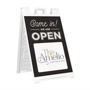 A We Are Open sandwich board sign for a coffee and tea shop