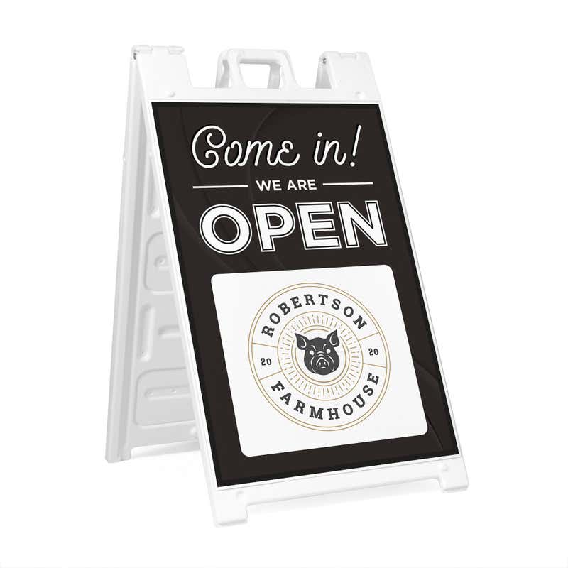 A sandwich board sign for a farmhouse that says We Are Open and features their logo