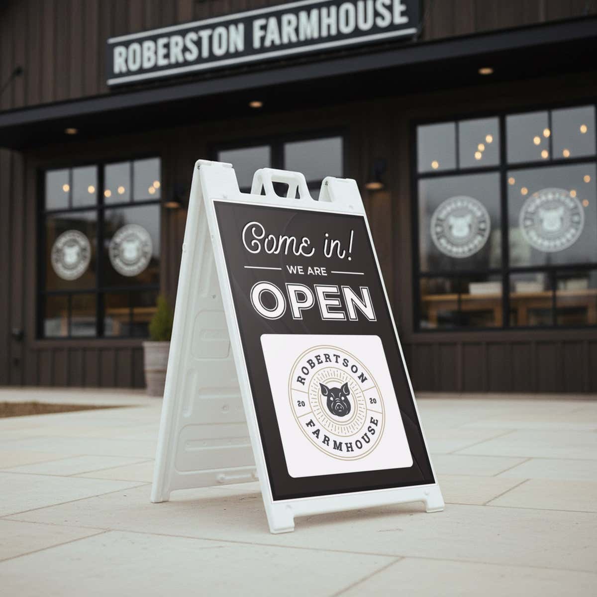 A sandwich board sign that says We Are Open and features the restaurant's logo
