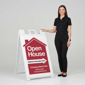 A woman standing next to an open house A-frame sign with her hand on the top of the sign