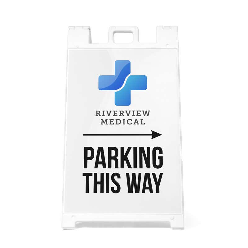 The Parking This Way sandwich board sign with an arrow and a medical logo