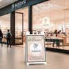 A beauty store welcome sign displayed inside a mall 