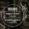 Custom Business Hour Sign with Floral Design displayed on a window