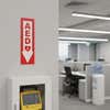 An AED sign above the AED in an office