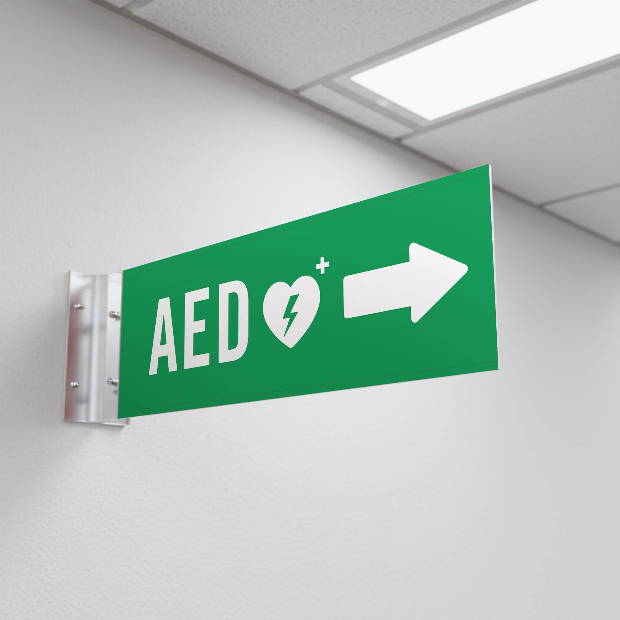 Green projecting AED sign in a hallway