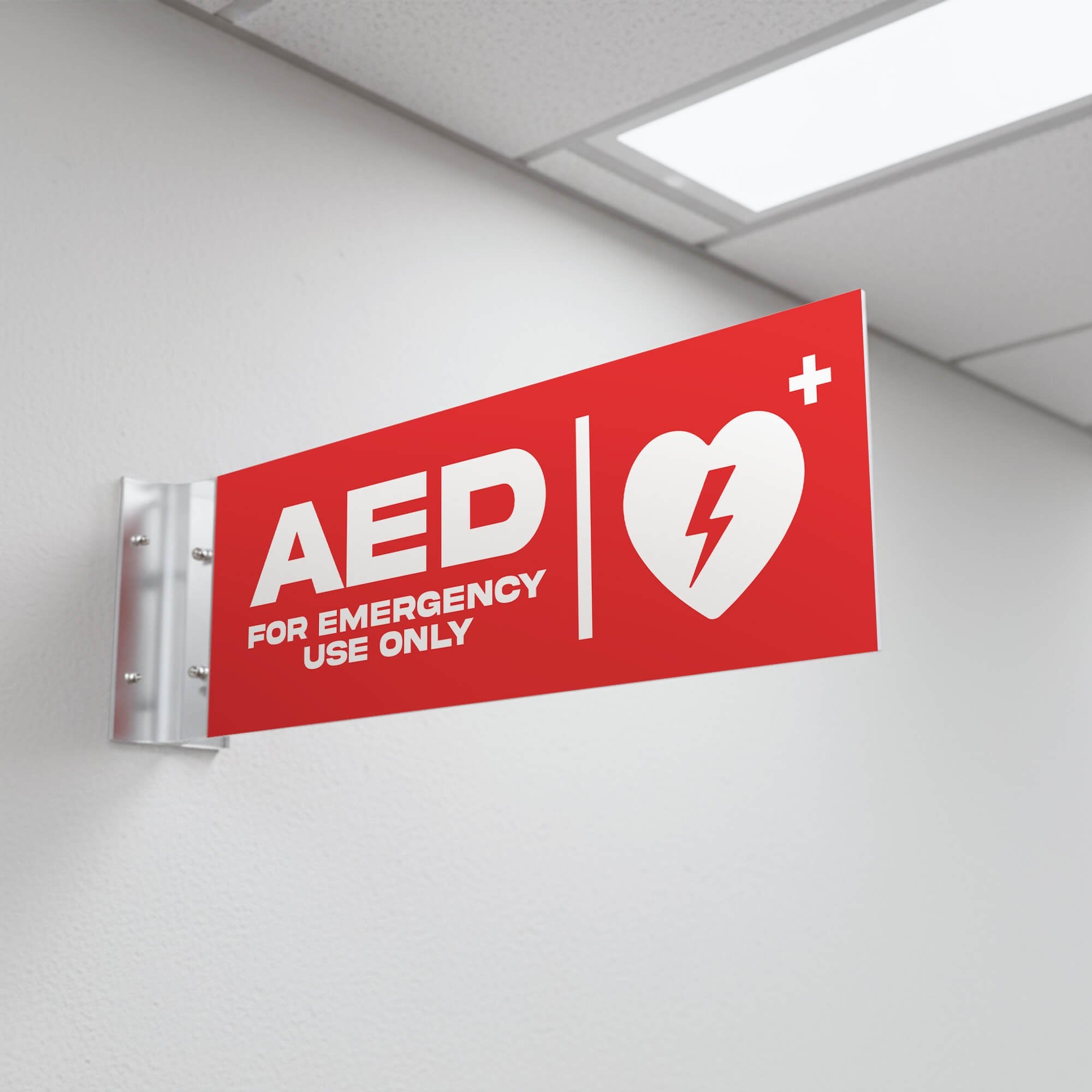 The red projecting AED sign in a hallway
