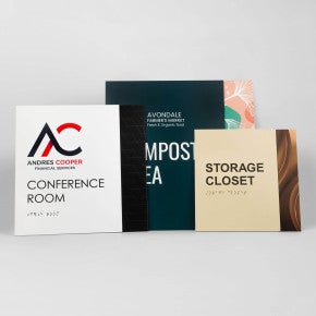 Three different sizes of the two-tone layered ADA sign next to each other