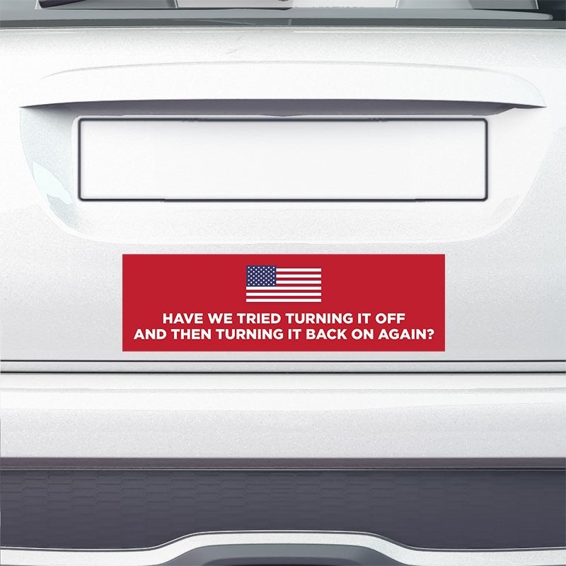 American Flag Funny Political Bumper Sticker on the bumper of a white car