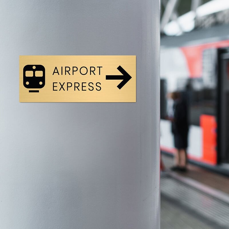 4x10 custom engraved brass sign displayed in an airport