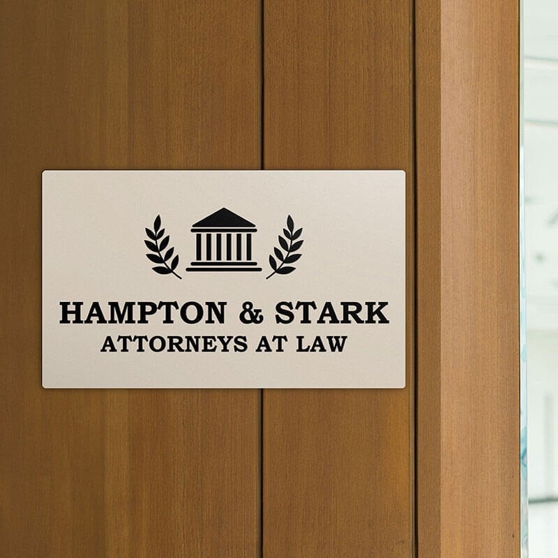 Engraved plastic sign displayed on a wooden wall