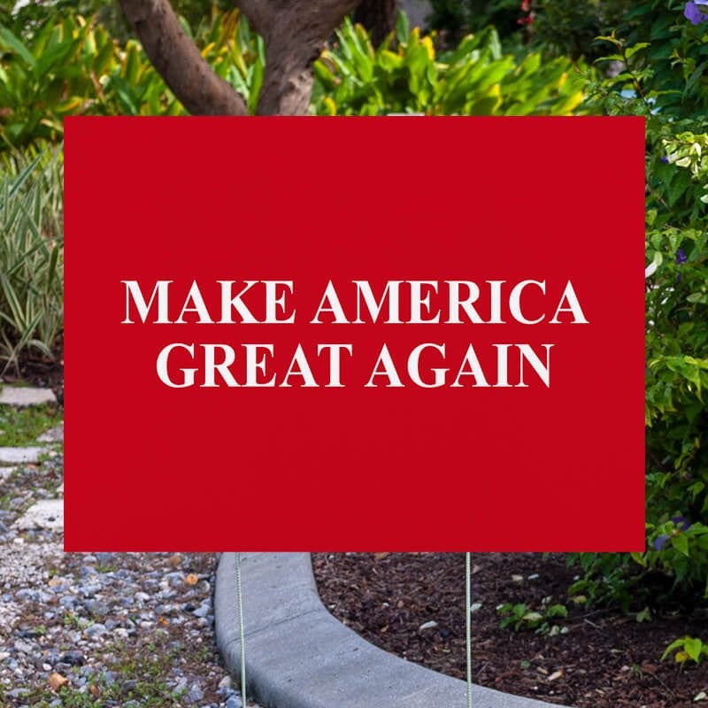 Maga yard sign next to pavement