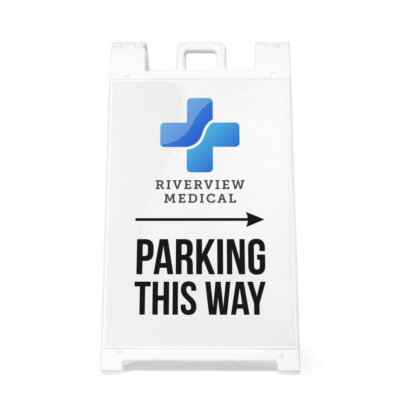 The Parking This Way sandwich board sign with an arrow and a medical logo