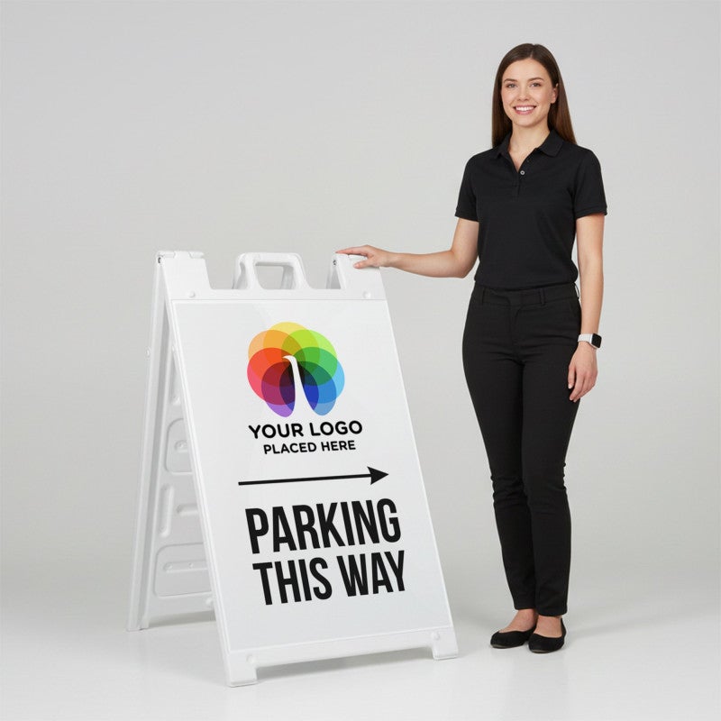 A woman standing next to an A-frame sign with her hand on the top of the sign