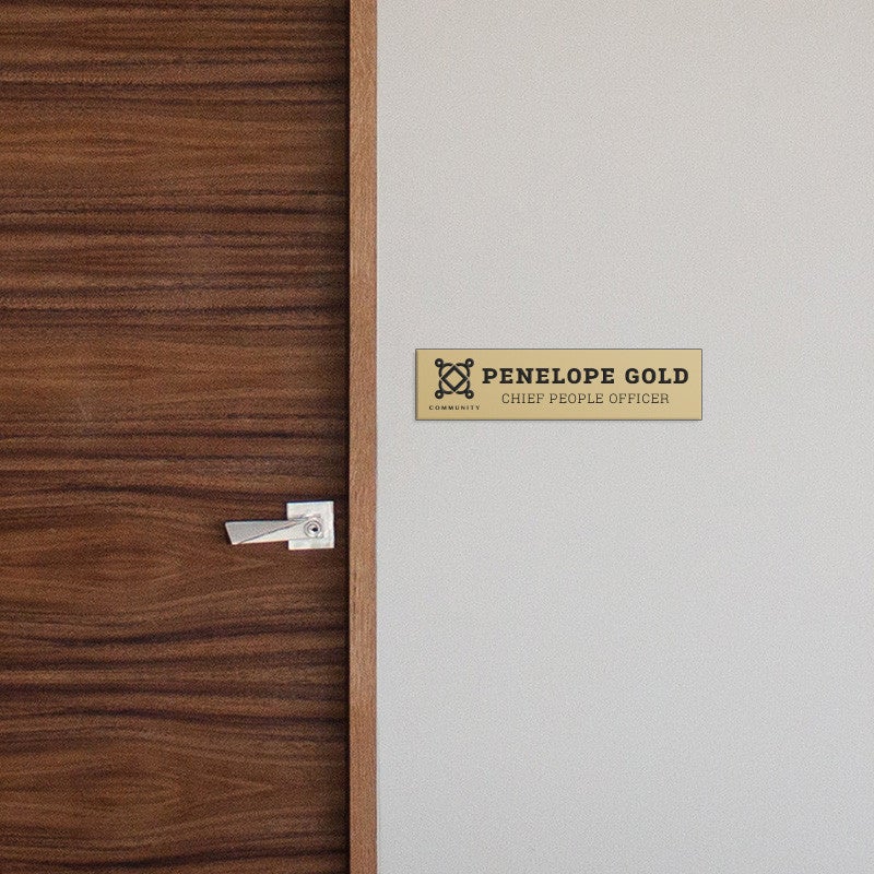 2 by 8 Plastic Sign By A Door As A Name Plate