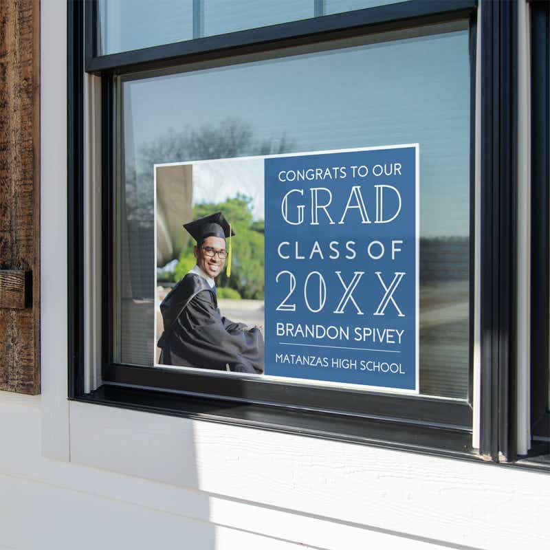 Congrats to our grad graduation yard sign in a window