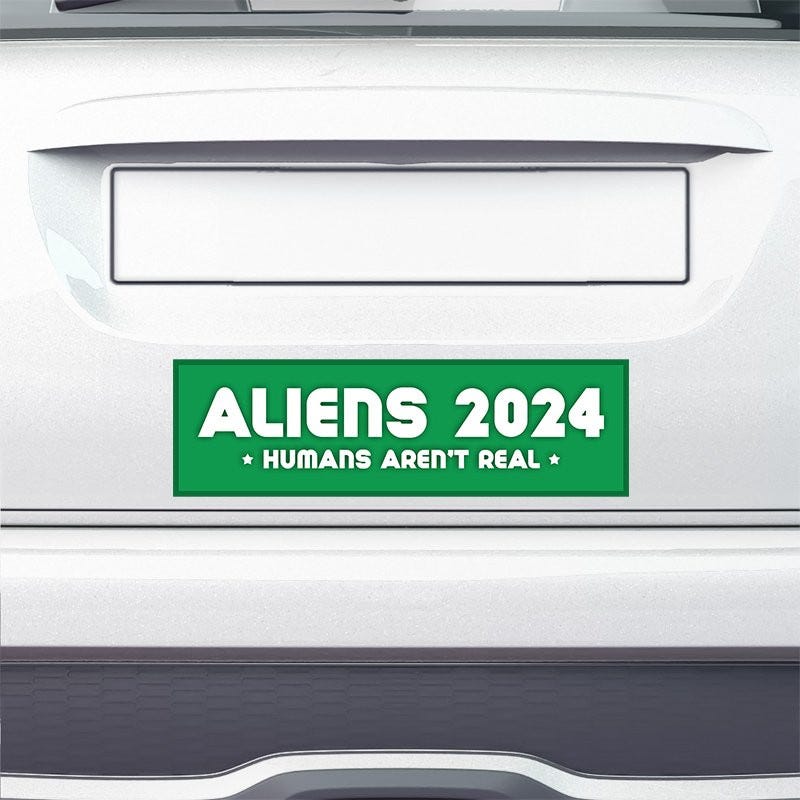 Aliens - Humans Aren't Real Bumper Sticker on the bumper of a white car