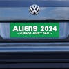 Aliens - Humans Aren't Real Bumper Sticker on a gray car