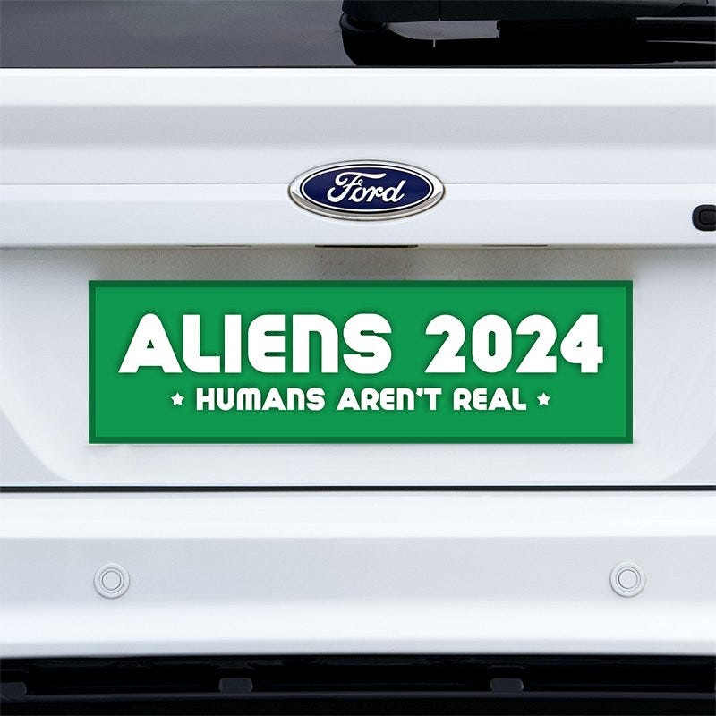 Aliens - Humans Aren't Real Bumper Sticker on a white truck