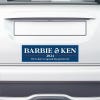 Barbie and Ken bumper sticker on the bumper of a white car