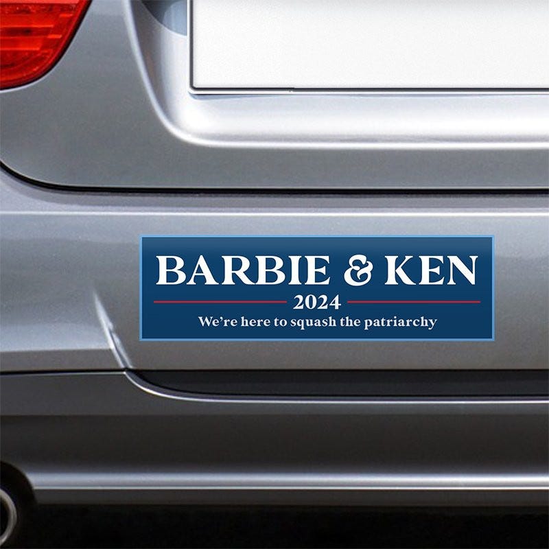 Barbie and Ken bumper sticker on the bumper of a gray car