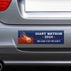 Giant Meteor Bumper Sticker on the bumper of a gray car