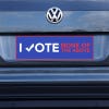 None of the Above Political Bumper Sticker on a gray car