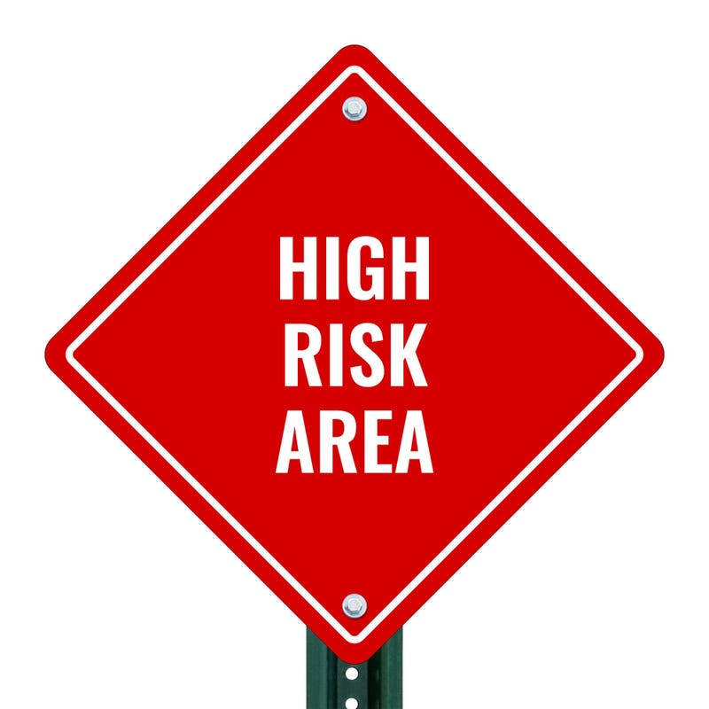 HIGH RISK AREA red aluminum diamond sign on a pole