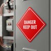 A red diamond aluminum sign by electrical wires with the message DANGER KEEP OUT