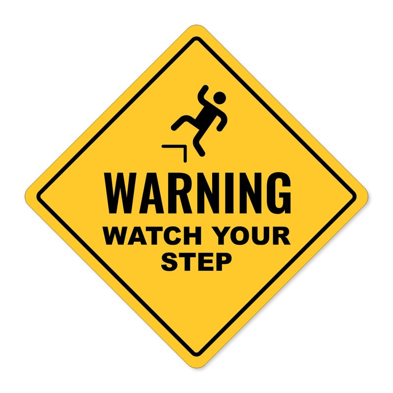 A custom yellow diamond sign with a warning and an icon