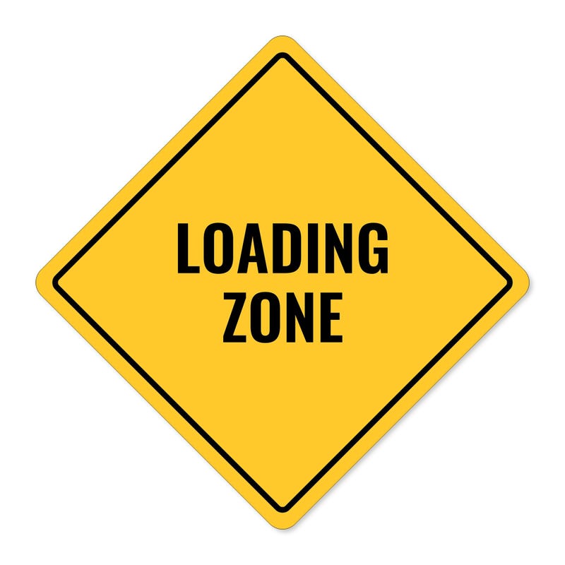 A yellow diamond sign with the message LOADING AREA