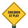 A yellow diamond sign on a post with the message CHILDREN AT PLAY