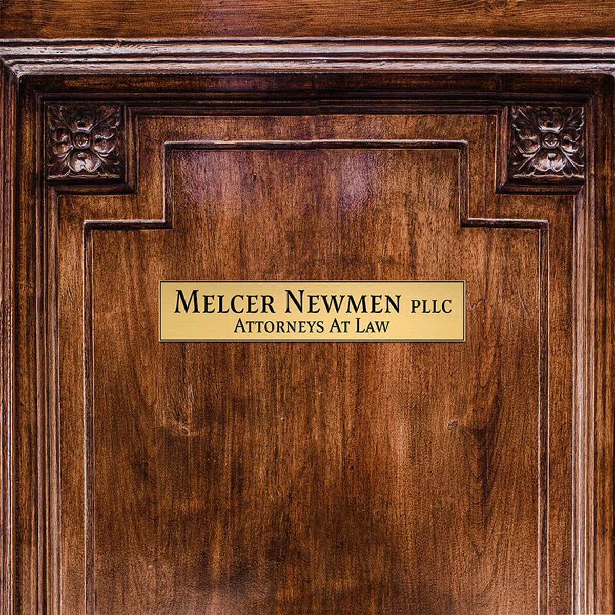 2x10 custom engraved brass sign displayed on a door