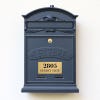 3x6 custom engraved brass sign on a gray mailbox