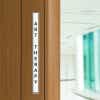 Engraved Sign Vertical 12 in x 1 in on a doorway