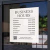 Business hours sign displayed on a store window
