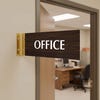 4” x 12” Corridor sign with walnut material color, white engraved text, and gold holder on a hallway wall with text saying “OFFICE”.