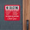 Red No soliciting sign in bold text. Do not ring bell or knock. No excuses, No exceptions in white text hung up on wall