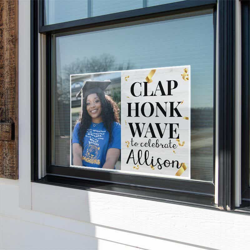 Clap, Honk, Wave Graduation Yard Sign in a Window