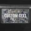 A close up of the Custom Military Camo front license plate on a black car