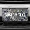 A close up of the Custom Military Camo front license plate on a white car