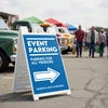 An event parking lot sandwich board for an exhibition displayed in a parking lot 