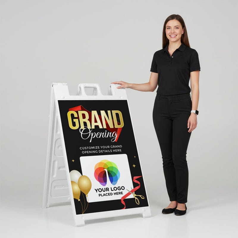 A woman standing next to the grand opening A-frame sign with her hand on the top of the sign
