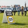 A $25 park here sandwich board displayed at a festival
