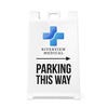 The Parking This Way sandwich board sign with an arrow and a medical logo