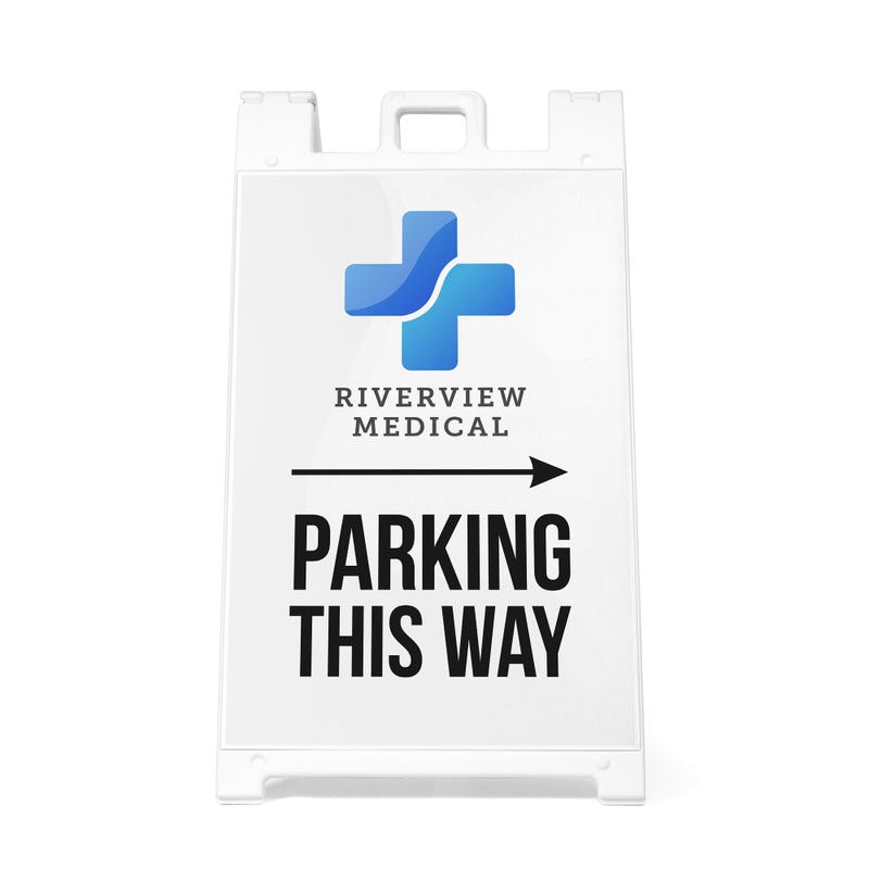 The Parking This Way sandwich board sign with an arrow and a medical logo