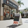 A 30% off sale sandwich board sign outside in front of a store