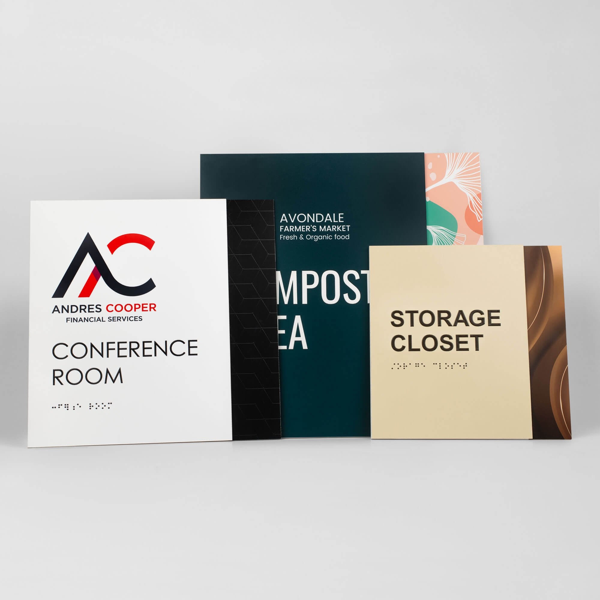 Three different sizes of the two-tone layered ADA sign next to each other