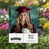 Graduation Gold Cap Garden Flag in a garden