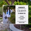 College bound graduation yard sign displayed next to pavement